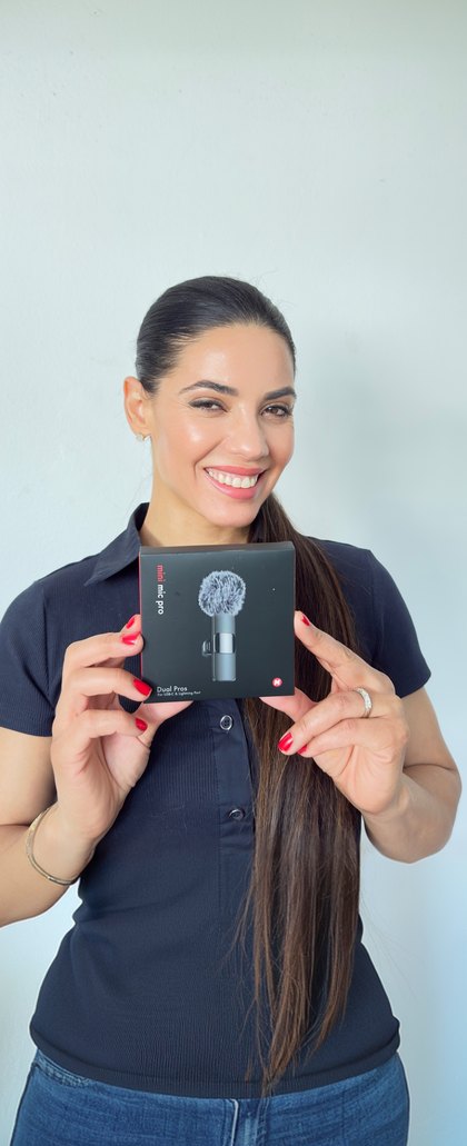 A creator smiles holding a Mini Mic Pro box