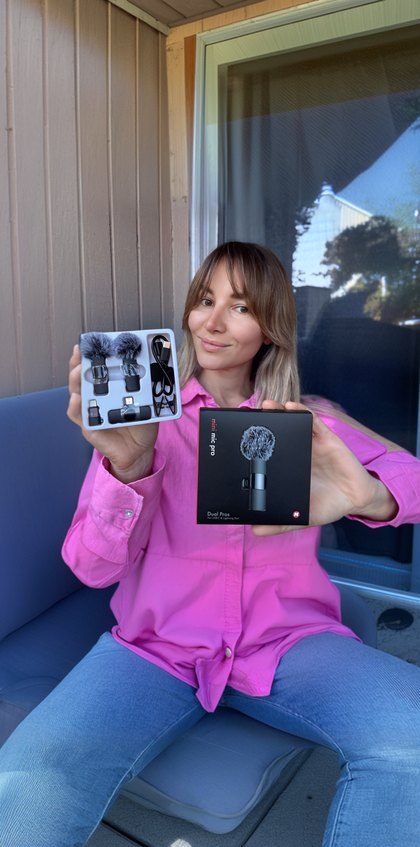 A creator holds up two Mini Mic Pro boxes